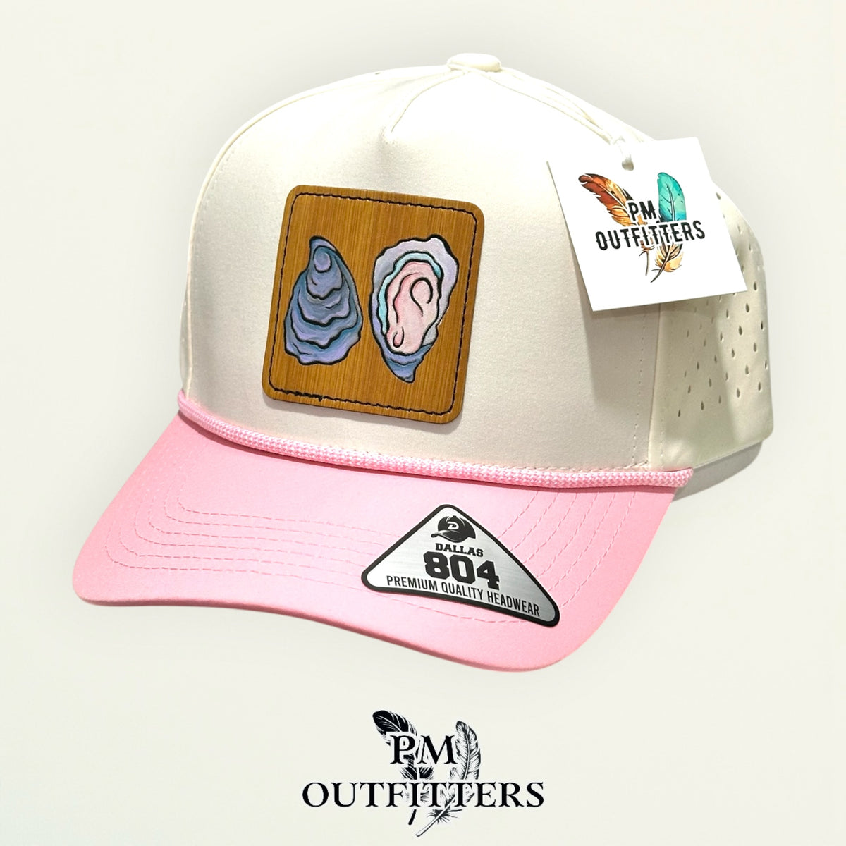 Hand-painted Gulf oyster patch on a cream and pink Dallas 804 waterproof rope trucker hat, PM Outfitters True Originals
