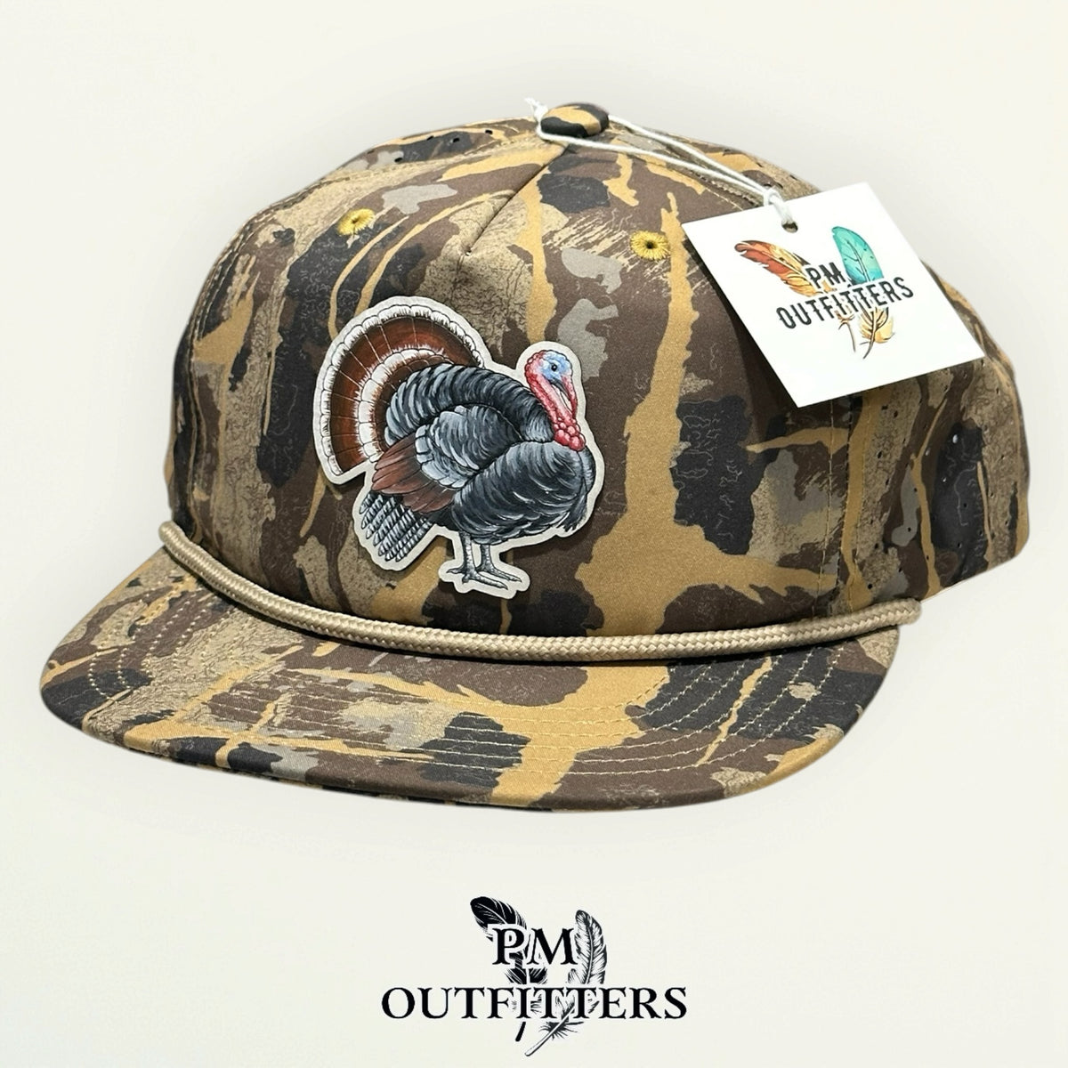 Hand-painted strutting turkey patch on a Sobro Marina Pro camo rope hat with tan rope, PM Outfitters True Originals