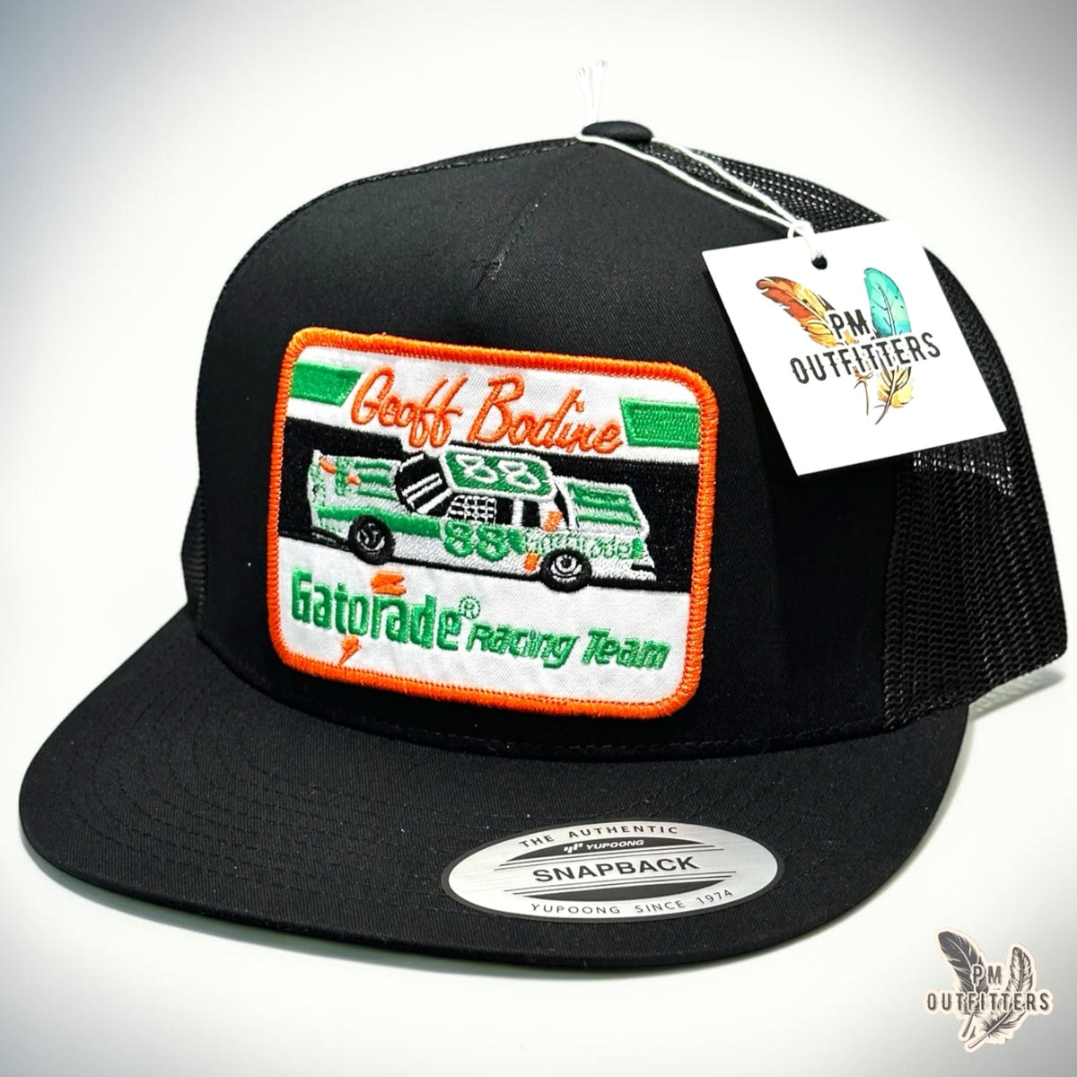 Geoff Bodine Gatorade Racing embroidered patch on an all-black Yupoong 6006 trucker hat, PM Outfitters