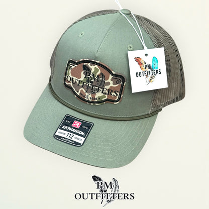 PM Outfitters hang tag loden green rope trucker hat