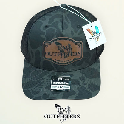 PM Outfitters hang tag Sable Duck camo trucker hat