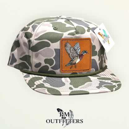 Hand-painted Wood Duck patch on a marsh duck camo Richardson 256P rope trucker hat, PM Outfitters True Originals