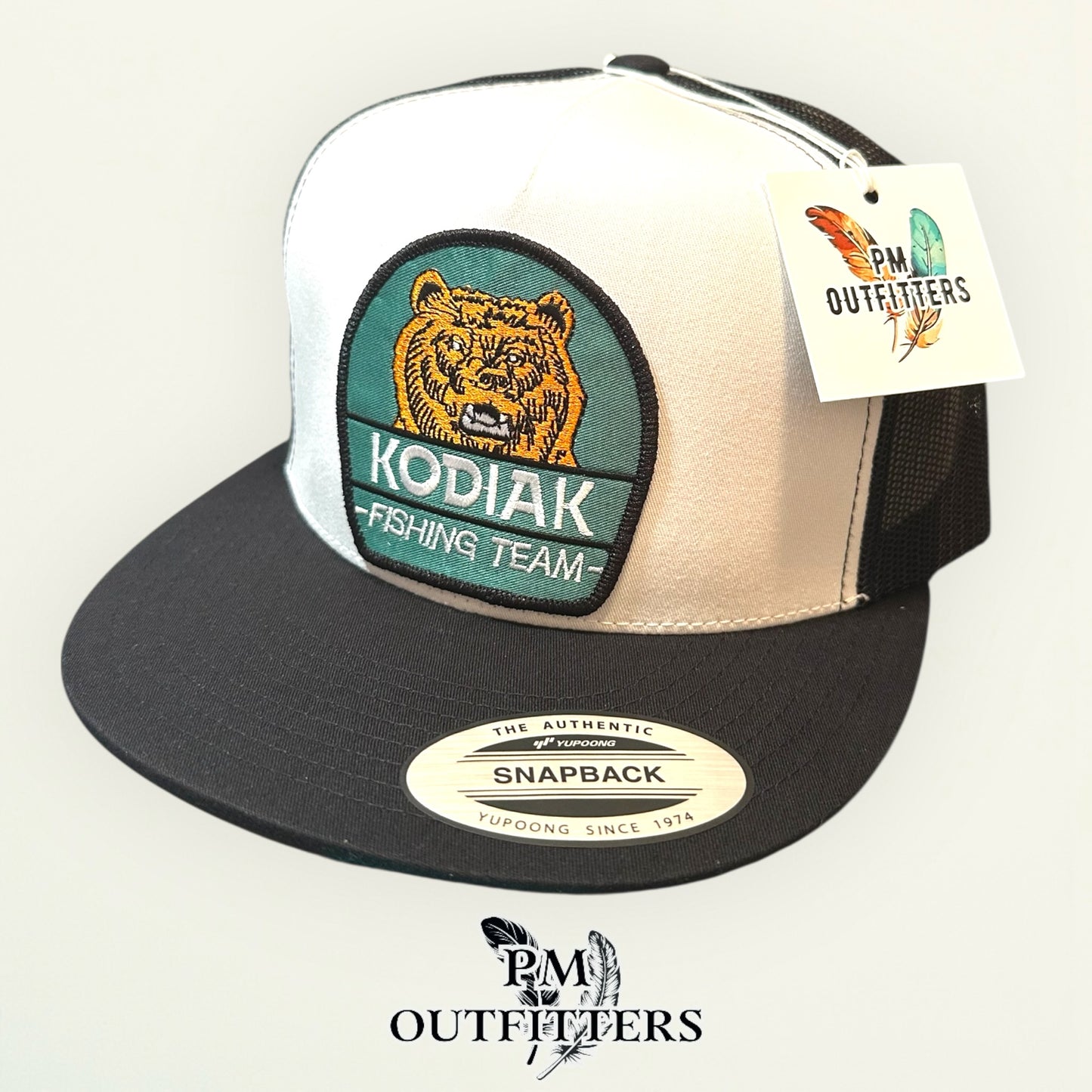 Kodiak Fishing Team Trucker Hat — PM Outfitters Heritage Patch | Yupoong Flat Bill White Black Alaska Wilderness