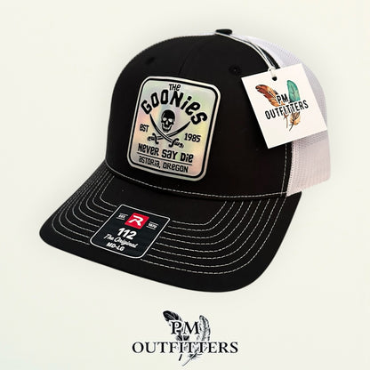 The Goonies Never Say Die Trucker Hat – PM Outfitters Holographic Vegan Leather Patch | Richardson 112 Black White