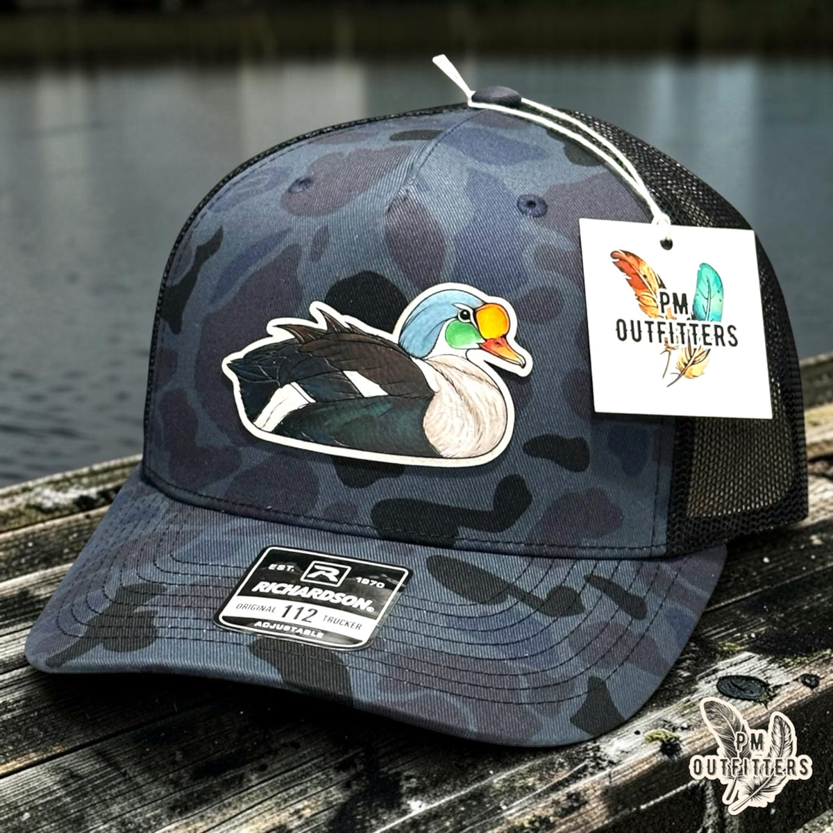 Hand-painted King Eider patch on a Richardson 112PFP Admiral duck camo trucker hat, PM Outfitters True Originals