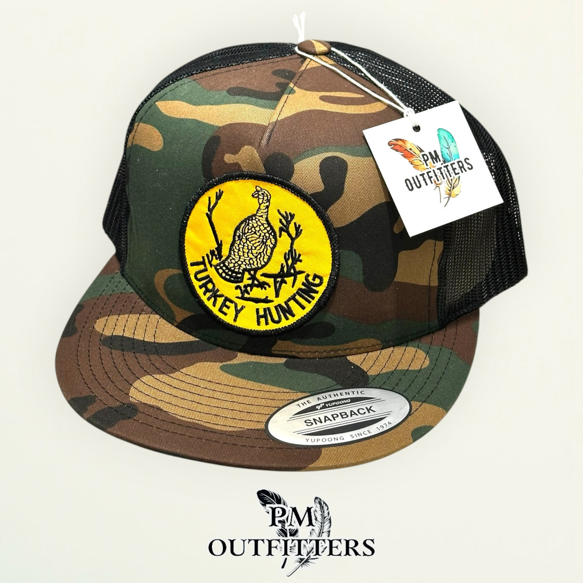 Turkey Hunting trucker hat displayed with PM Outfitters branded hang tag