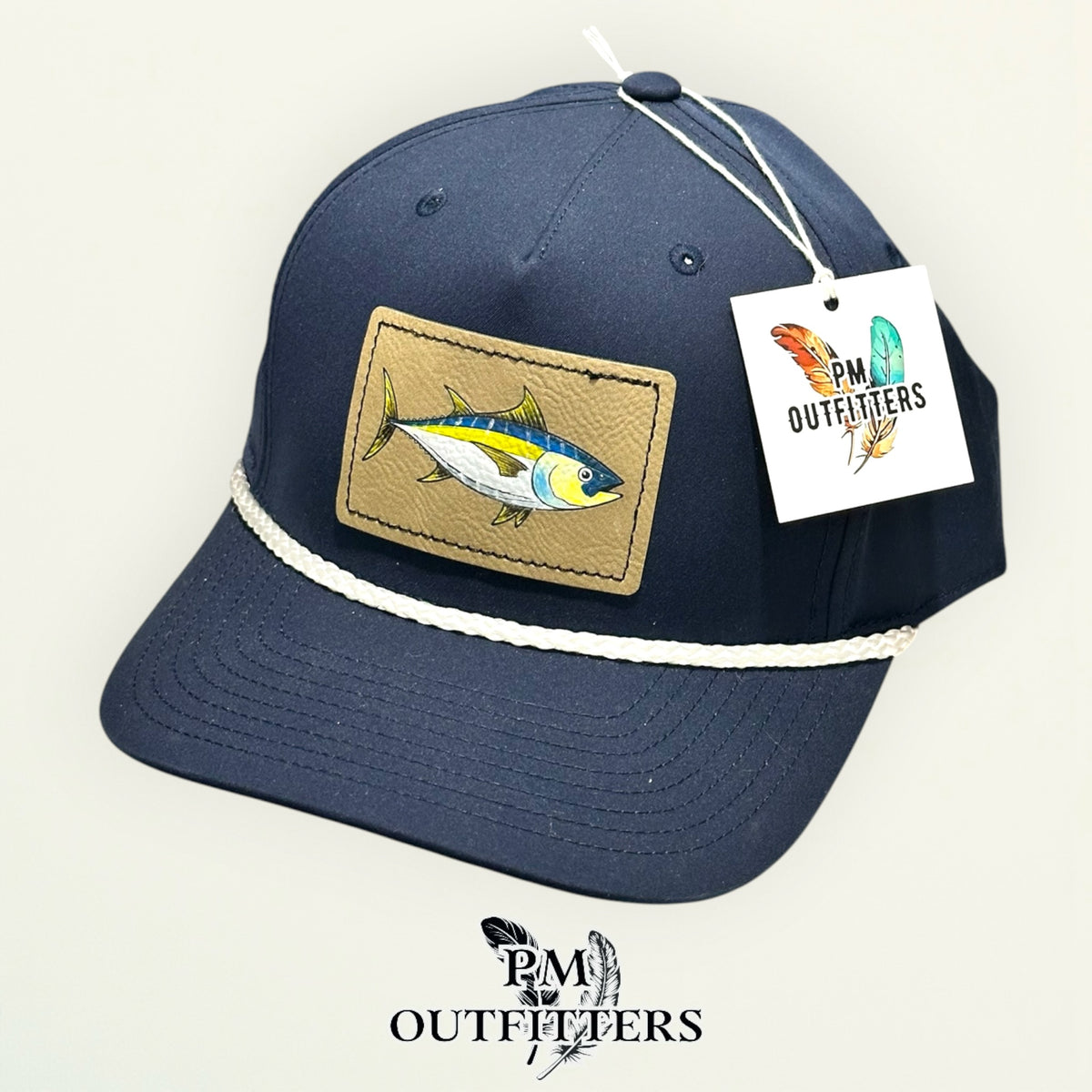 Hand-painted yellowfin tuna performance rope cap displayed with PM Outfitters branded hang tag