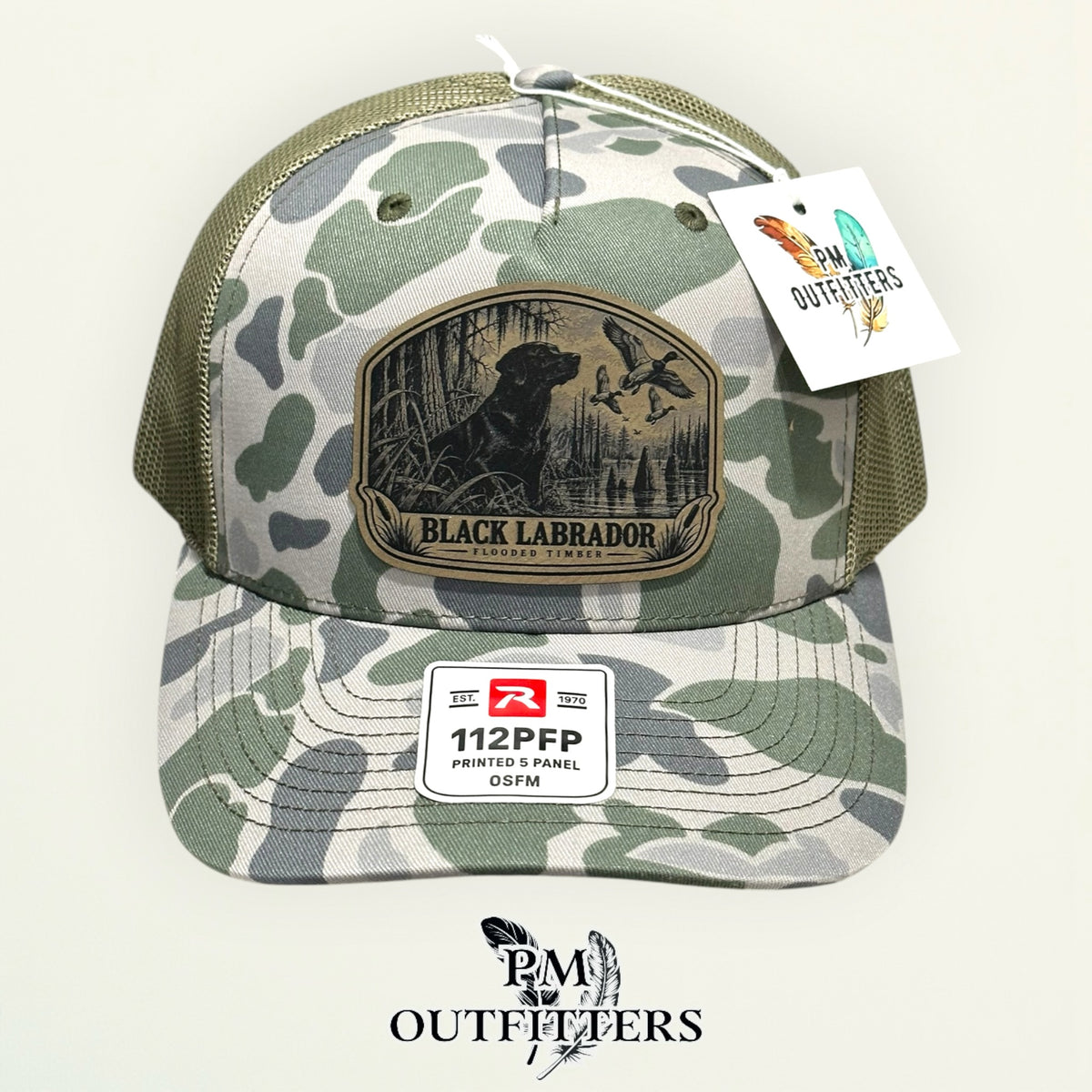 Black Labrador duck hunting leather patch on Richardson 112PFP Marsh camo hat – front view