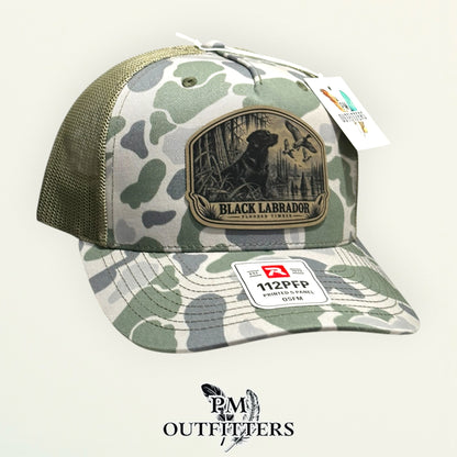 Black Labrador flooded timber camo trucker hat – left angle showing mesh back