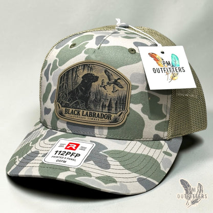 Black Labrador flooded timber leather patch hat on Richardson 112PFP Marsh camo – angled front view