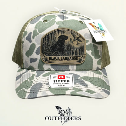 Black Labrador flooded timber patch Richardson 112PFP Marsh camo trucker hat – straight front view