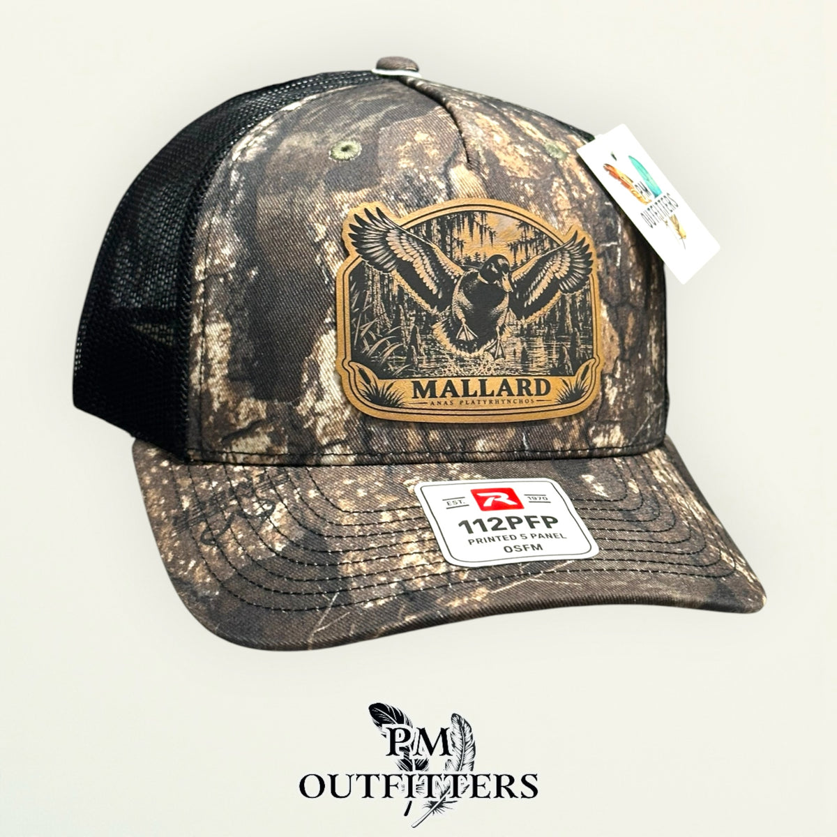 Mallard flooded timber leather patch camo trucker hat – left angle with black mesh