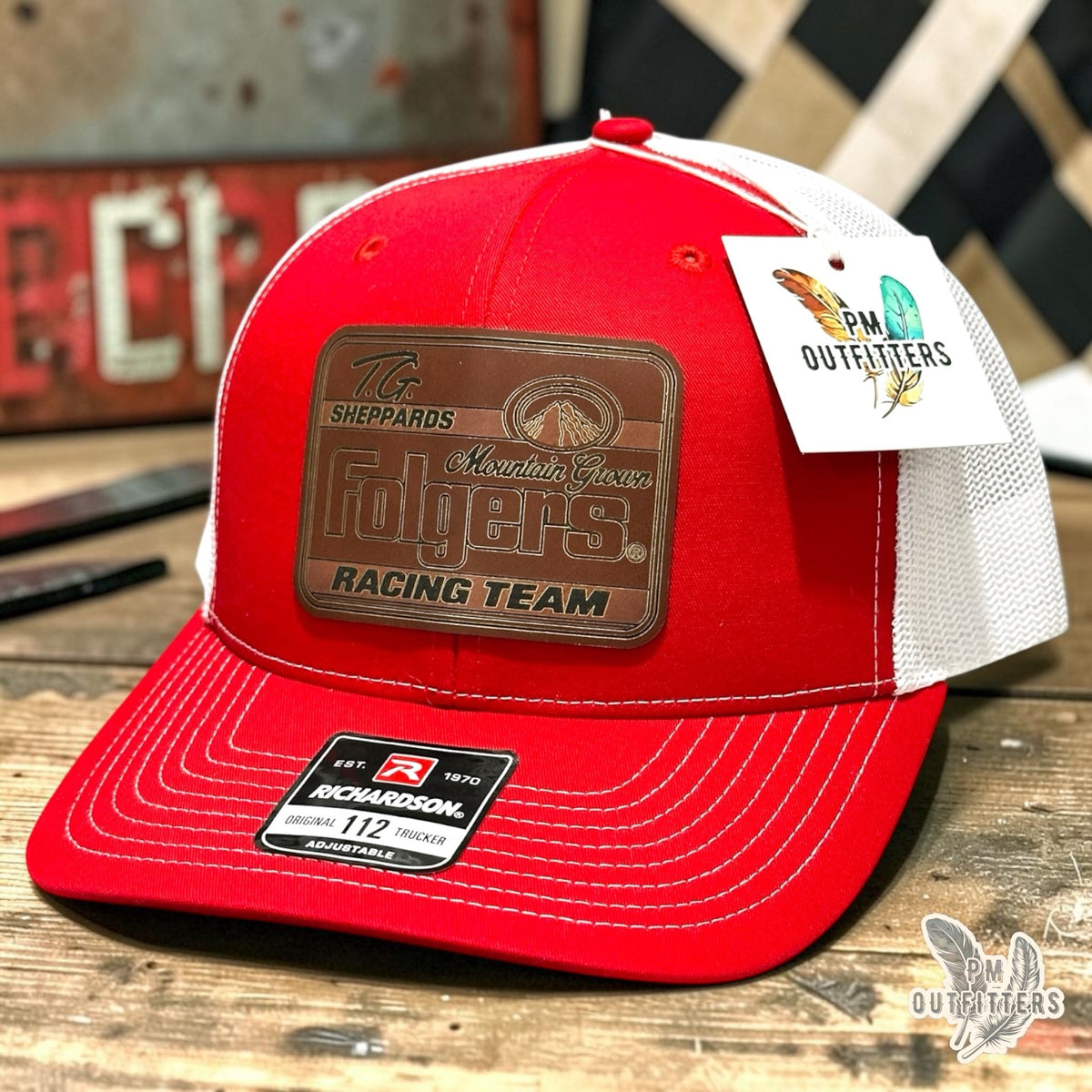 TG Sheppard Folgers Racing Team custom laser-engraved leatherette patch on Richardson 112 red and white mesh trucker hat, featured view