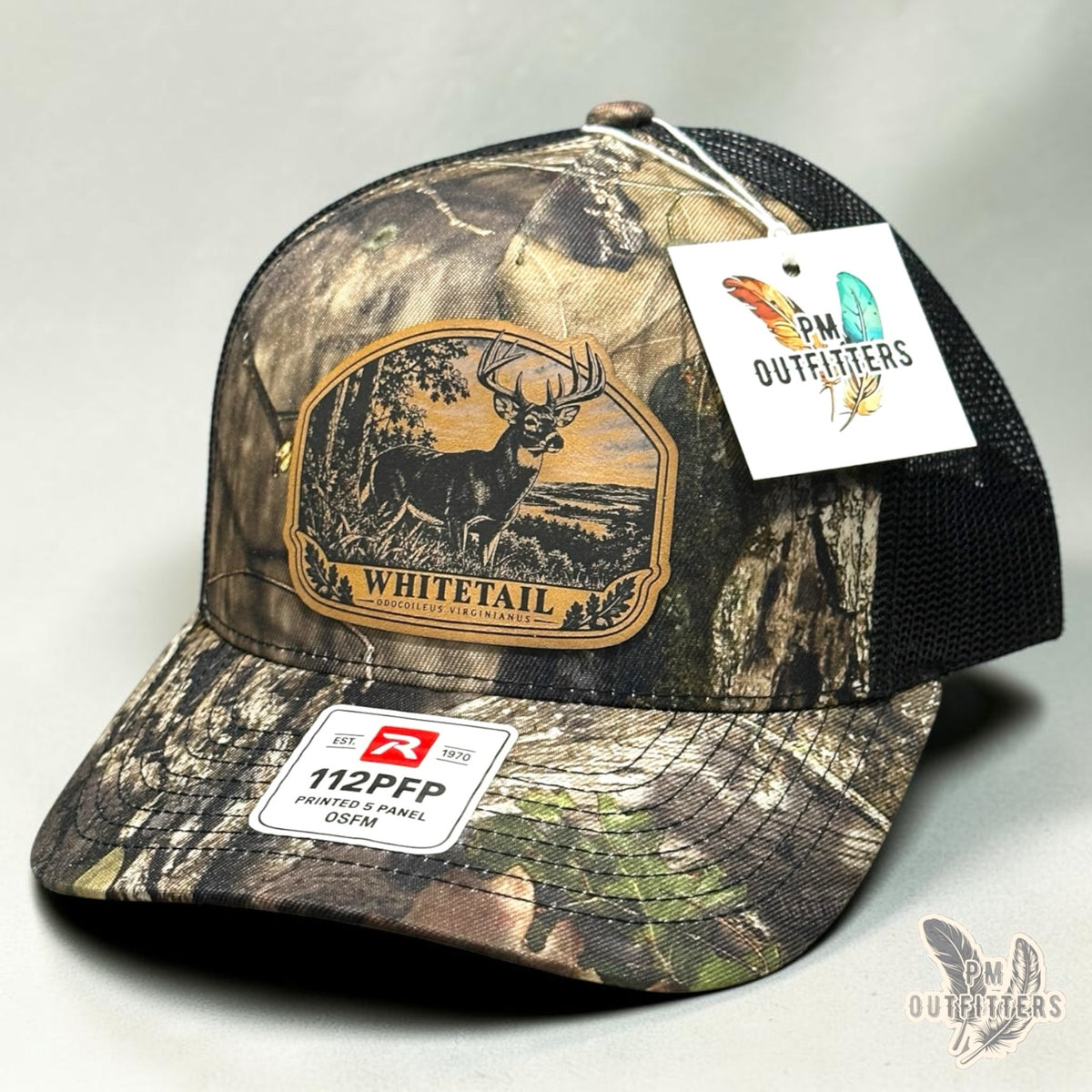 Whitetail deer leather patch hat on Richardson 112PFP Country DNA camo – angled front view